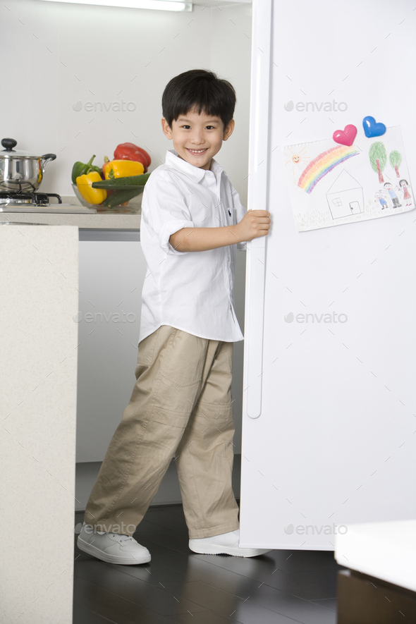 Young boy opening refrigerator