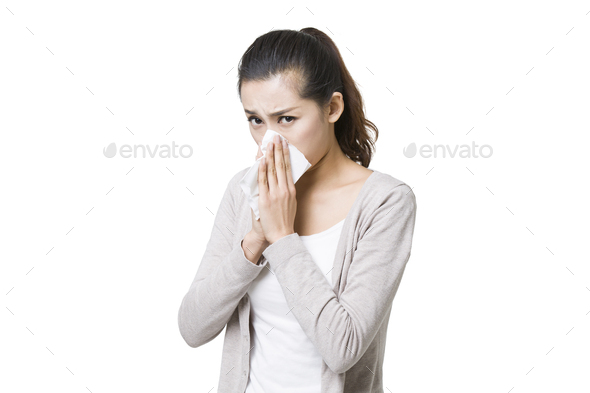 Young woman blowing nose - Stock Photo - Images