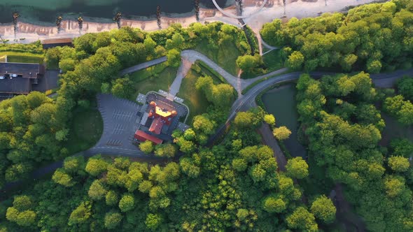 Tracking TopDown Drone Shot of Forest Trees Infinite Bridge and Vast Ocean alt