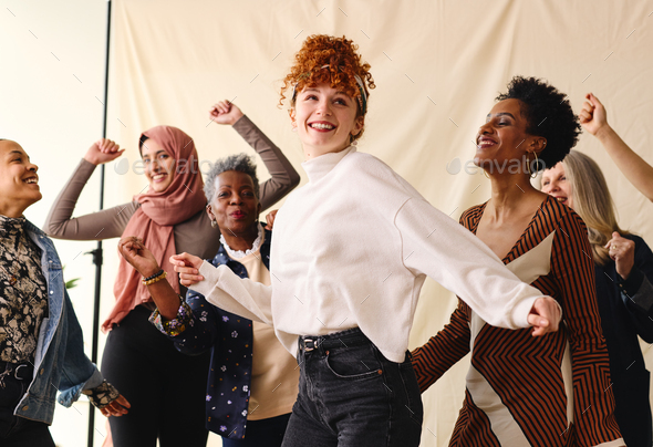 International Women\'s Day candid portrait of multi ethnic mixed age range women dancing