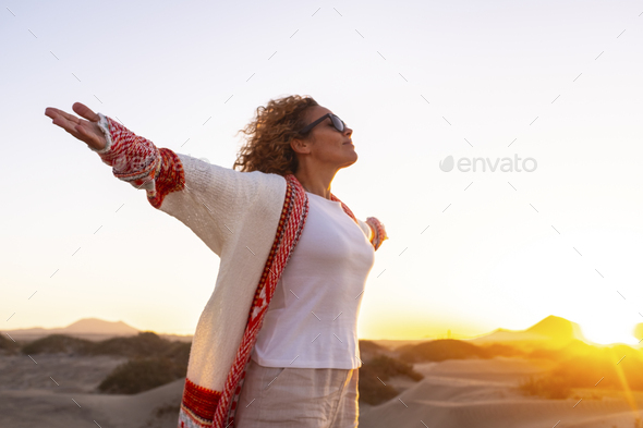 Inner balance and happiness concept with young woman opening arms and outstretching