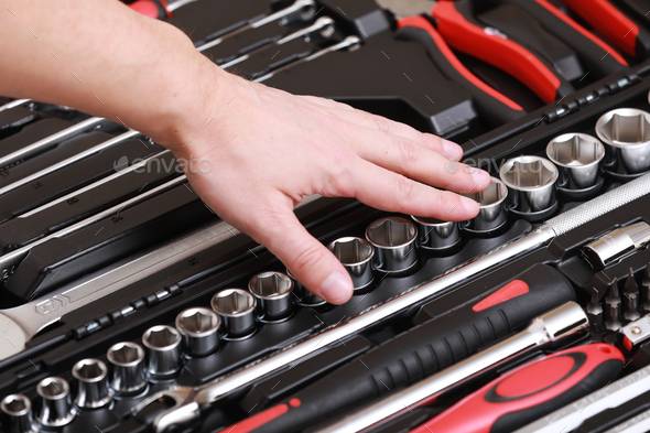 Customers or worker, builder, repairman, handyman, at the store chooses wrench, nuts, instrument