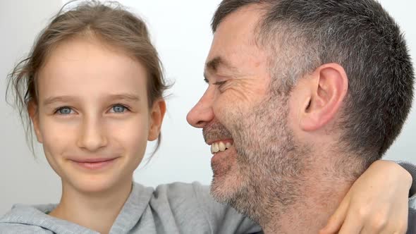 Family Portrait of Senior Father and Little Blond Daughters are Hugging Indoors and Smiling Fathers alt