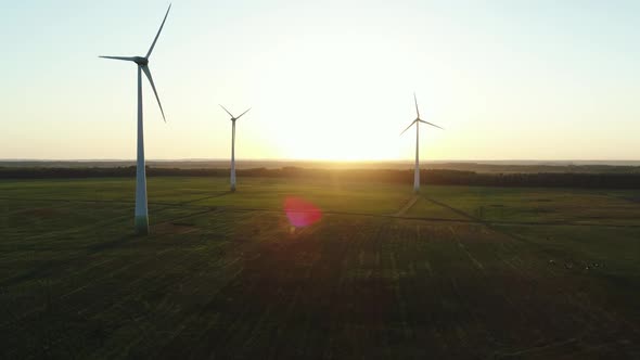 Windmills Power Plant In Green Meaddow