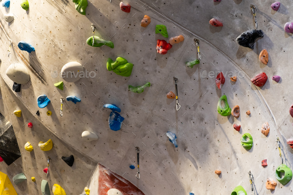 Artificial rock climbing wall with various colored grips Stock Photo by ...