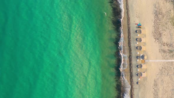 Aerial view of sea and sand beach on a sunny day.