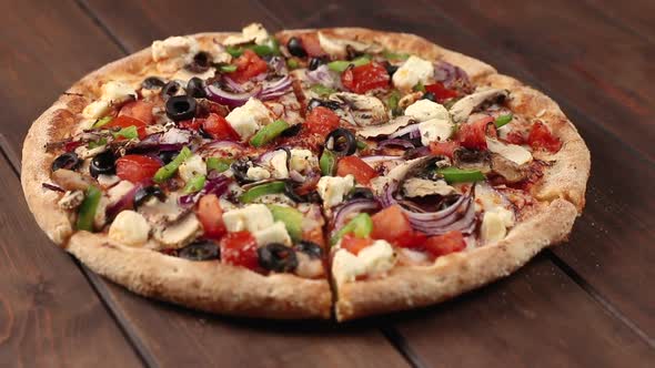 round pizza with chicken meat, vegetables, mushrooms and cheese rotating