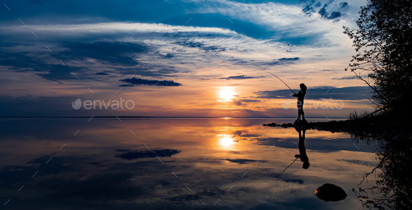 Woman fishing on Fishing rod spinning at sunset background. Stock Photo by  cookelma