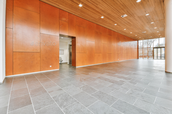 Spacious lobby of a residential building with a glass exit to the outside