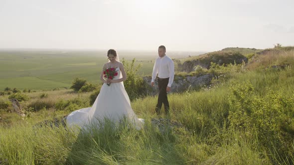 Groom Walks to His Bride in the Green Plants alt