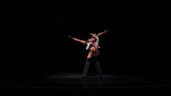 Ballroom Dancers Pair on Dark Stage in Slow Motion