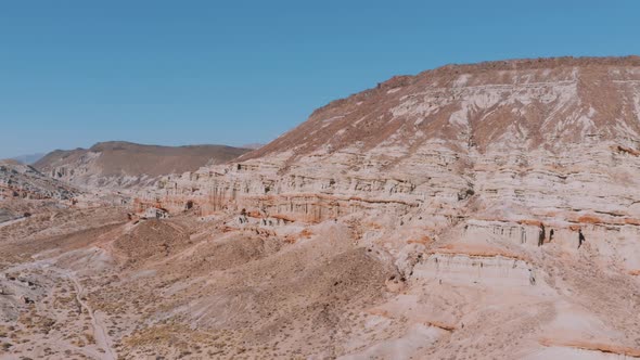 Aerial Pan of Red Rock Canyon cliffs in California, summer day alt