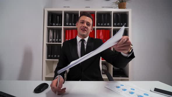 Handsome Young Salesman Inviting You To Sign a Lease or a Service Agreement alt