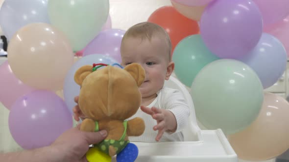 Happy Baby Boy Celebrating Birthday at Home Father Giving a Toy Cute Kid at Birthday Party One Year alt