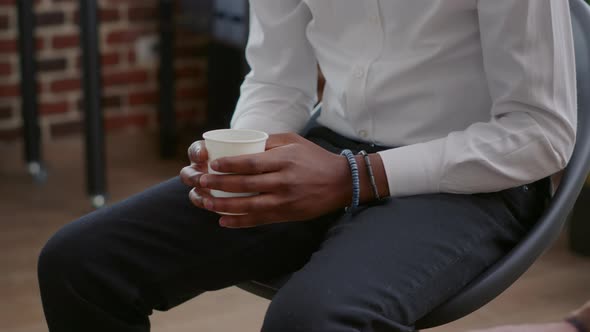 Close Up of African American Man Fewling Nervous While Holding Cup of Coffee at Aa Meeting alt