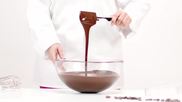 Closeup Female Chef Mixing Dark Melted Chocolate in Glass Bowl, Slow Motion