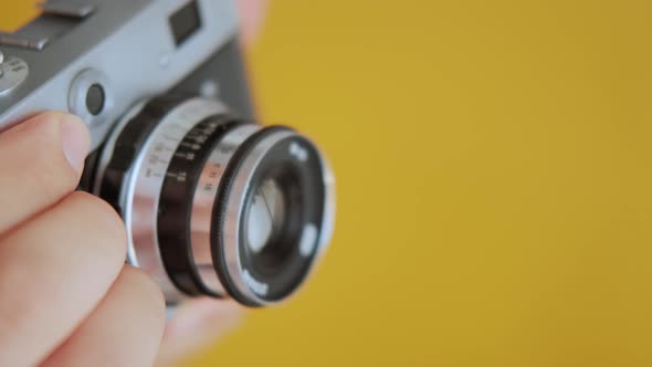 Close up Photographer Hold Vintage Film Camera in Hands.