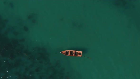 Aerial up above boat among azure water and coral reefs alt