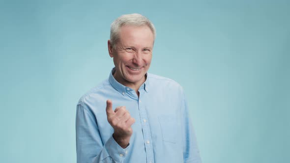 Cheerful Senior Man Shaking His Finger to Camera and Laughing Playfully Reproaching Enjoying Joke alt