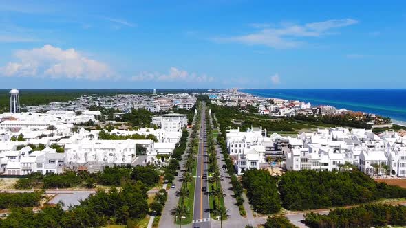 Aerial View of Alys Beach slowly lowering to show the entrance, a lot of white modern houses on the alt