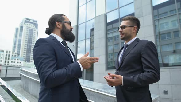 Male Business Partners Communicating Outdoor, Discussing Plans for Future