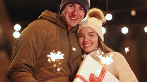 Lovers Travelling to Europe at the Height of Christmas Holidays Hugging and Burning the Sparklers
