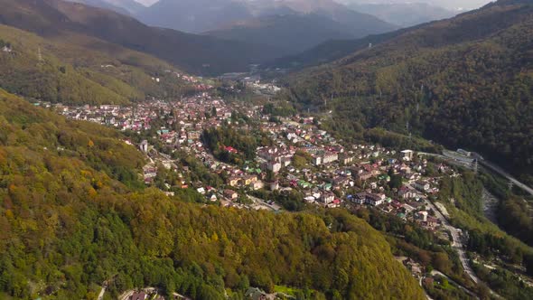 Panoramic aerial view of a settlement near mountains.