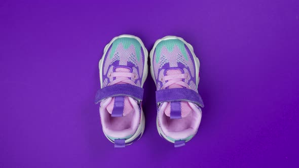 Multicolored Girls Sneakers with Mershmello on Purple Background Stop Motion