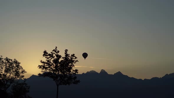 The Balloon Takes Off Over the Line of Mountains