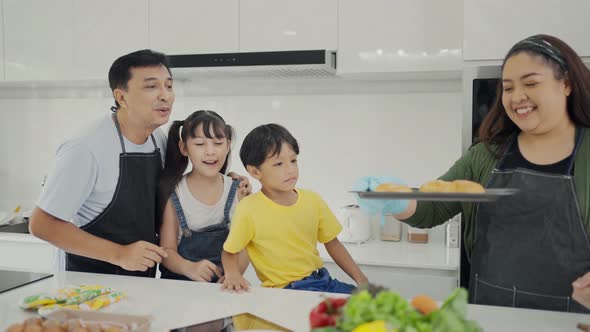 Happy family mom dad and kids siblings cooking together.