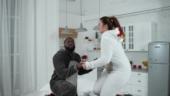 Joyful Couple in Love Dancing Holding Hands on Bed alt