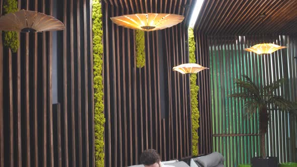 Young Attractive Guy Is Making the Acquaintance of Beautiful Woman in the Salon. alt