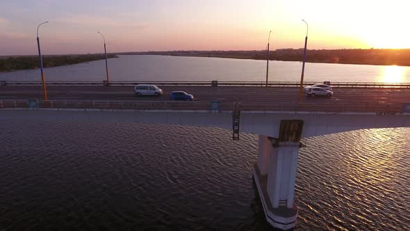 Aerial Shot of a Lofty Bridge Over the Dnipro at Shining Sunset in Summer