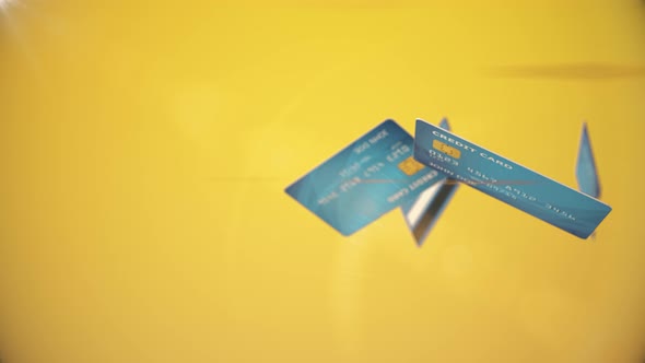 credit cards rotate among themselves on yellow background