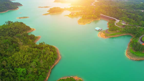 An aerial view from a drone flying over a dam, beautiful turquoise water alt