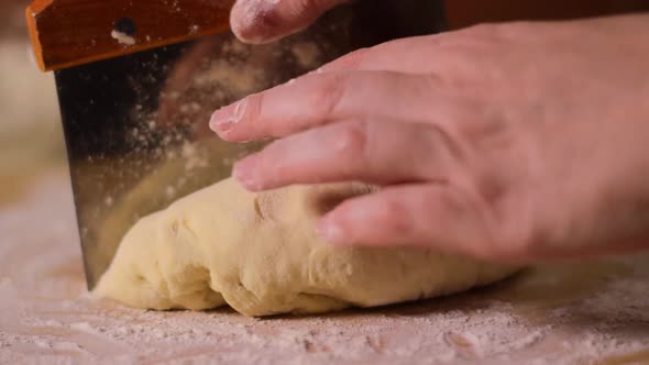 Cutting yeast dough with dough scraper alt
