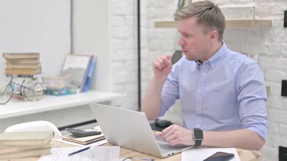 Businessman Coughing While Working alt