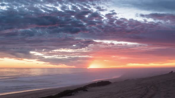 Colorful Sunset with Bloody Sky and Red Clouds over Ocean Beach alt