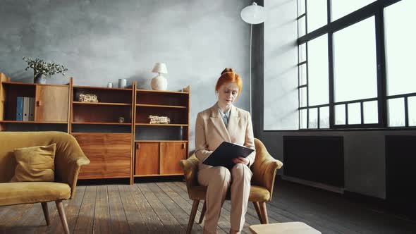 Female Psychologist Taking Notes and Planning Her Workday in Office alt