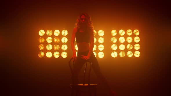 Girl Erotically Squat Performing Sexy Dance Near Chair alt