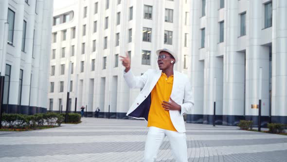 Black guy dancer in orange t shirt and white suit alt