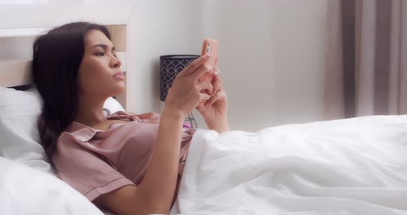 Woman is Upset That She Read Bad News on Her Phone While Lying in Bed