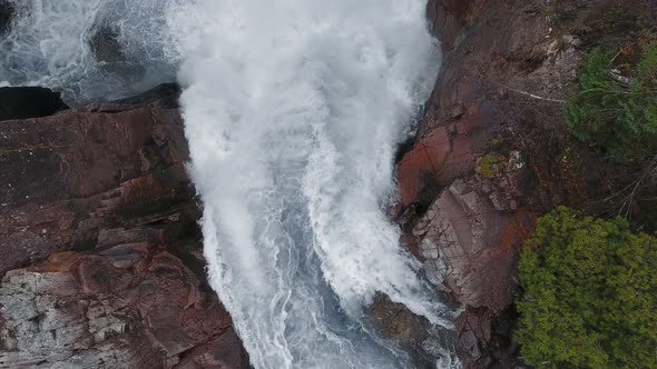 Overhead aerial camera captures a waterfall and rocky shores in Aguasabon Falls, Ontario, Canada alt