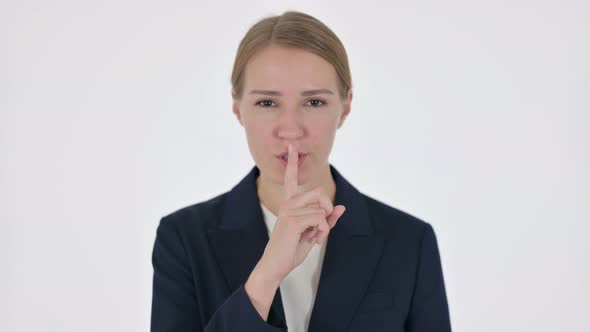 Young Businesswoman with Finger on Lips Silence White Screen alt