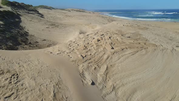 Drone Flying Away From Sand Dunes Seen at Beach