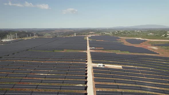 Aerial pullback revealing energy Solar farm on countryside field, Algarve