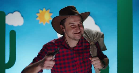 Happy Robber Looking at Camera with Sack and Handgun alt