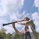 Girl Plays Clarinet Against Sky - VideoHive Item for Sale