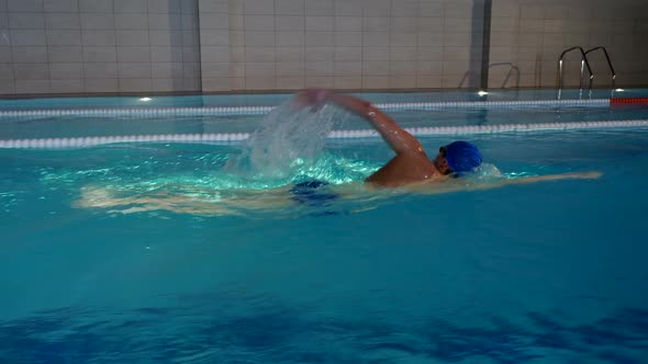  Professional Male Swimmer Performing Freestyle In Swimming Pool