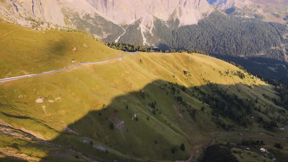 Aerial view reveals Dolomites, Val Gardena, Italy. Beautiful scenario, green and sky blue. Tourism c alt